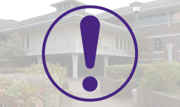 Alert symbol against the backdrop of a photo of the Civic Centre in Esher