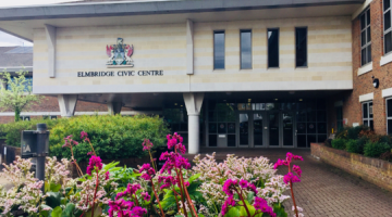 Exterior of the Elmbridge civic centre with pink flowers