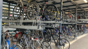 A collection of bicycles on a rack.