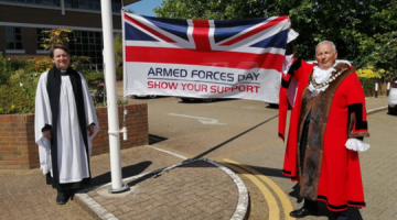 The Mayor of Elmbridge and the Mayor's Chaplain marking the start of Armed Forces week by raising the flag.