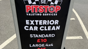 A sign for Pitstop Valeting Services promoting an exterior car clean