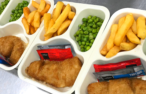 Meals on wheels ready to be delivered - fish, chips and peas