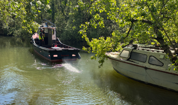 Unauthorised boat on Cigarette Island being towed away