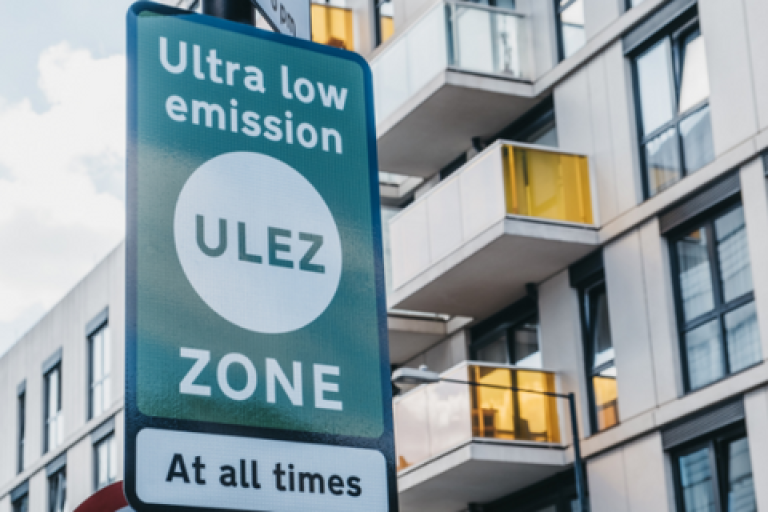A ULEZ sign in front of apartments