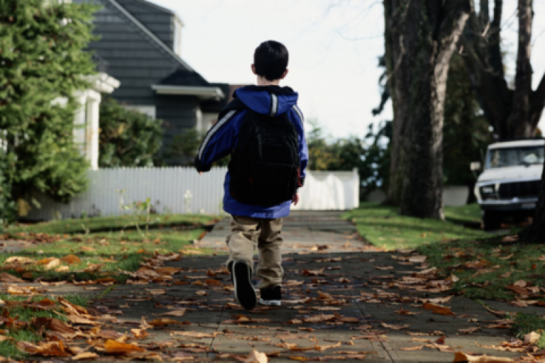 Child walking on pavement