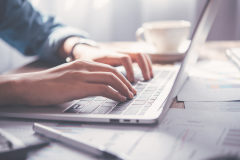 A person typing on a laptop