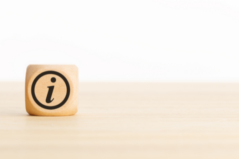 Information icon on a wooden cube