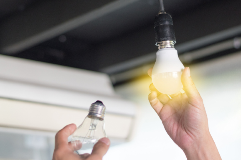 An image of a person replacing a light bult.