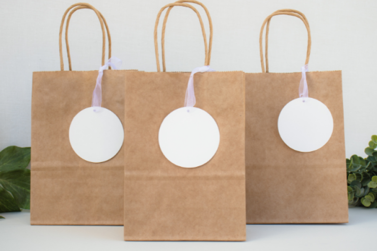 An image showing three paper gift bags resting on the floor