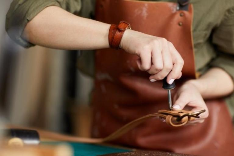 Woman fixing a belt in a workshop