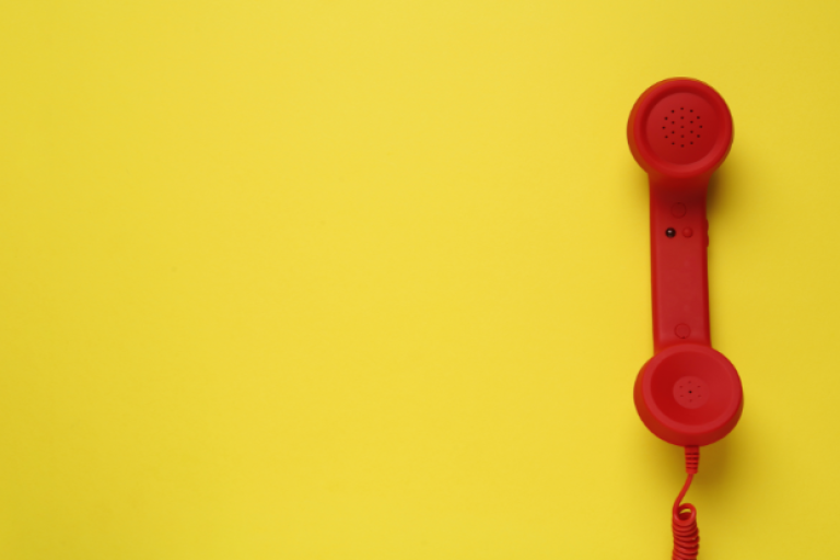 Red telephone on a yellow background