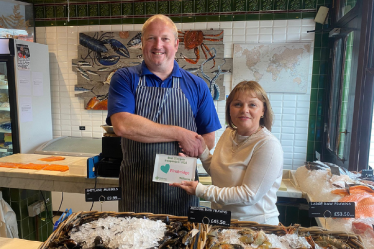Cllr Hewens presenting an award to Williams & Bunkell fishmongers.