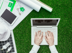 Laptop on grass with other energy efficient products.