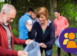 Litter picking - lady putting rubbish in bag, while man holds bag open