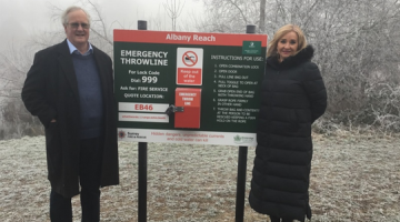 Two people standing beside the newly installed throwlines at Albany Reach.