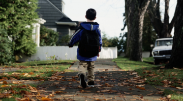 Child walking on pavement