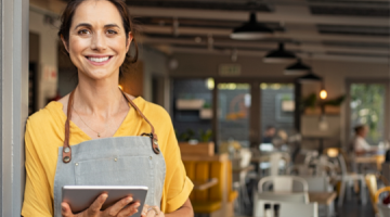 Waitress standing in front of a restaurant