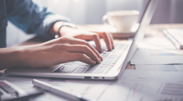 A person typing on a laptop