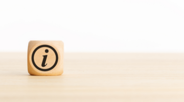 Information icon on a wooden cube