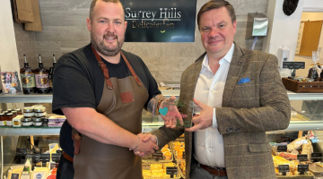 Cllr Robin Stephens presenting Surrey Hills Delicatessen with their award.