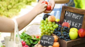 Someone buying fruit and vegetables from a market