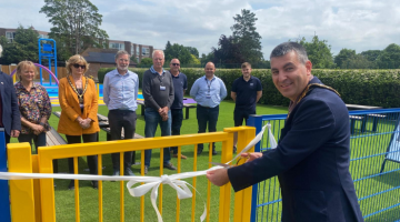 Mayor Steve Bax cuts white ribbon at Weybridge splash pad
