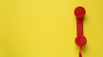 Red telephone on a yellow background