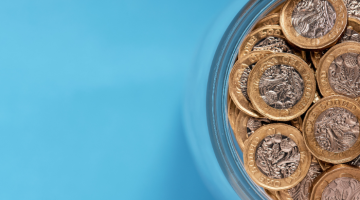 Blue background with a jar filled with pound coins