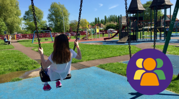 Girl swinging on swing in Elmbridge play area