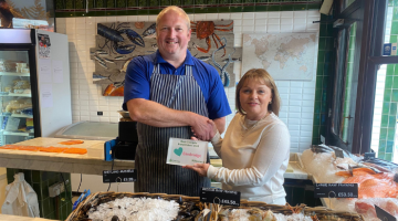 Cllr Hewens presenting an award to Williams & Bunkell fishmongers.